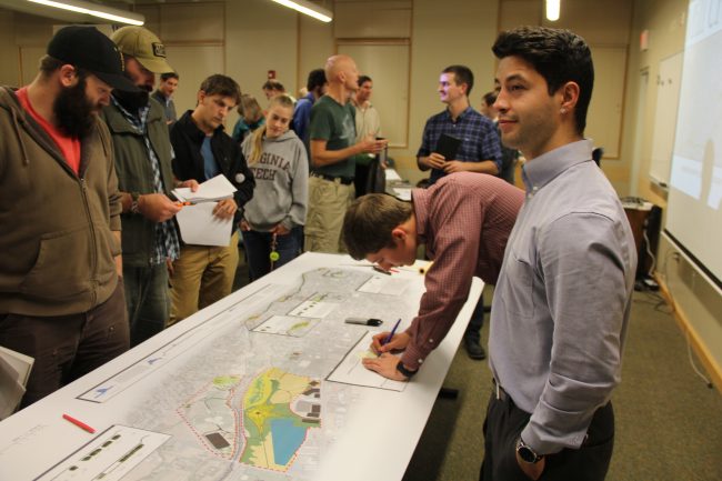 adults looking at large map of Mill Creek
