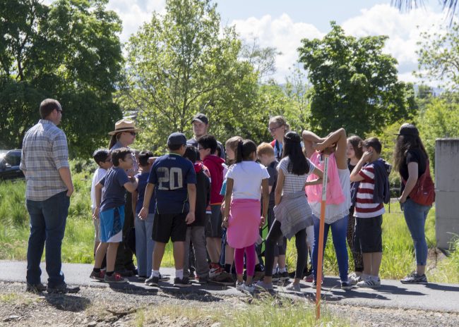 group of adults and children on creek trail