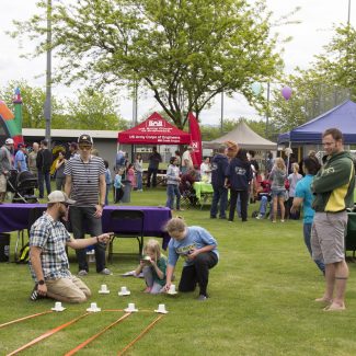 children at activity station adults observing