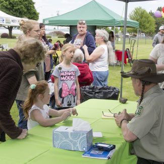adults and children by informational booth